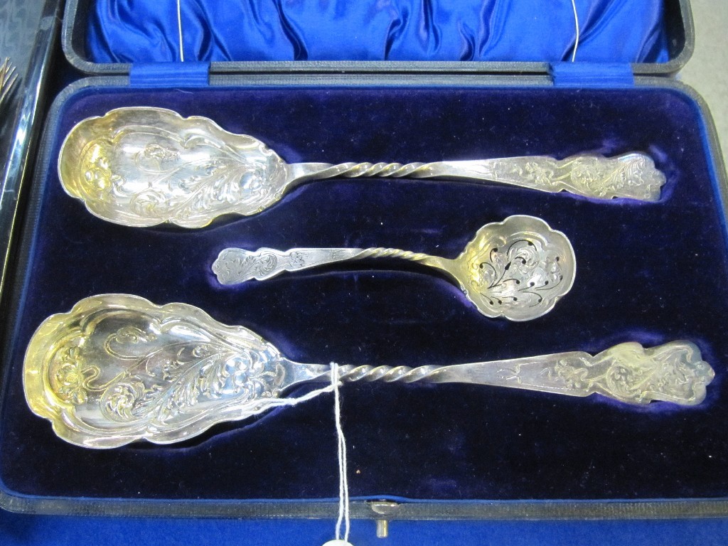 Appraisal: A cased pair of EP serving spoons and a sifter