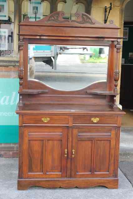 Appraisal: AN EDWARDIAN CHIFFONIER with raised mirror back and turned column