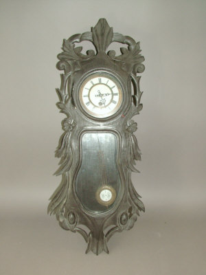 Appraisal: A Continental Black Forest regulator type wall clock with carved