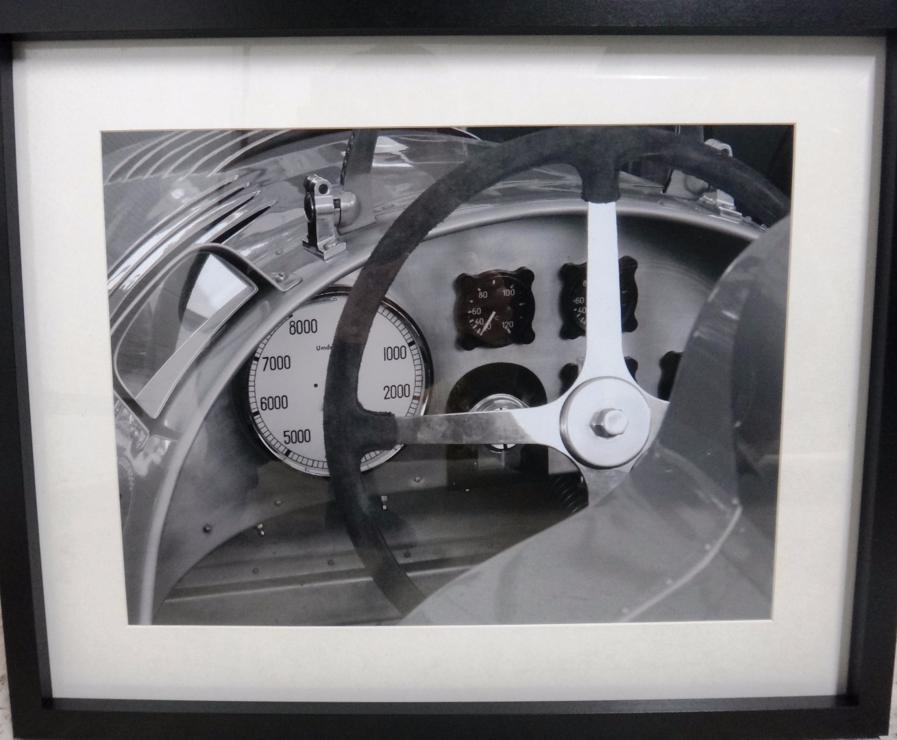 Appraisal: A framed black and white photograph of a pre-war Auto