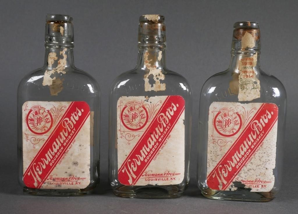 Appraisal: Three half-pint Herrmann Bros bourbon bottles Louisville Kentucky Dated shipping