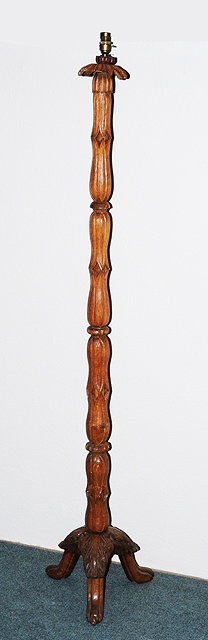 Appraisal: AN ARTS AND CRAFTS STYLE CARVED OAK STANDARD LAMP carved