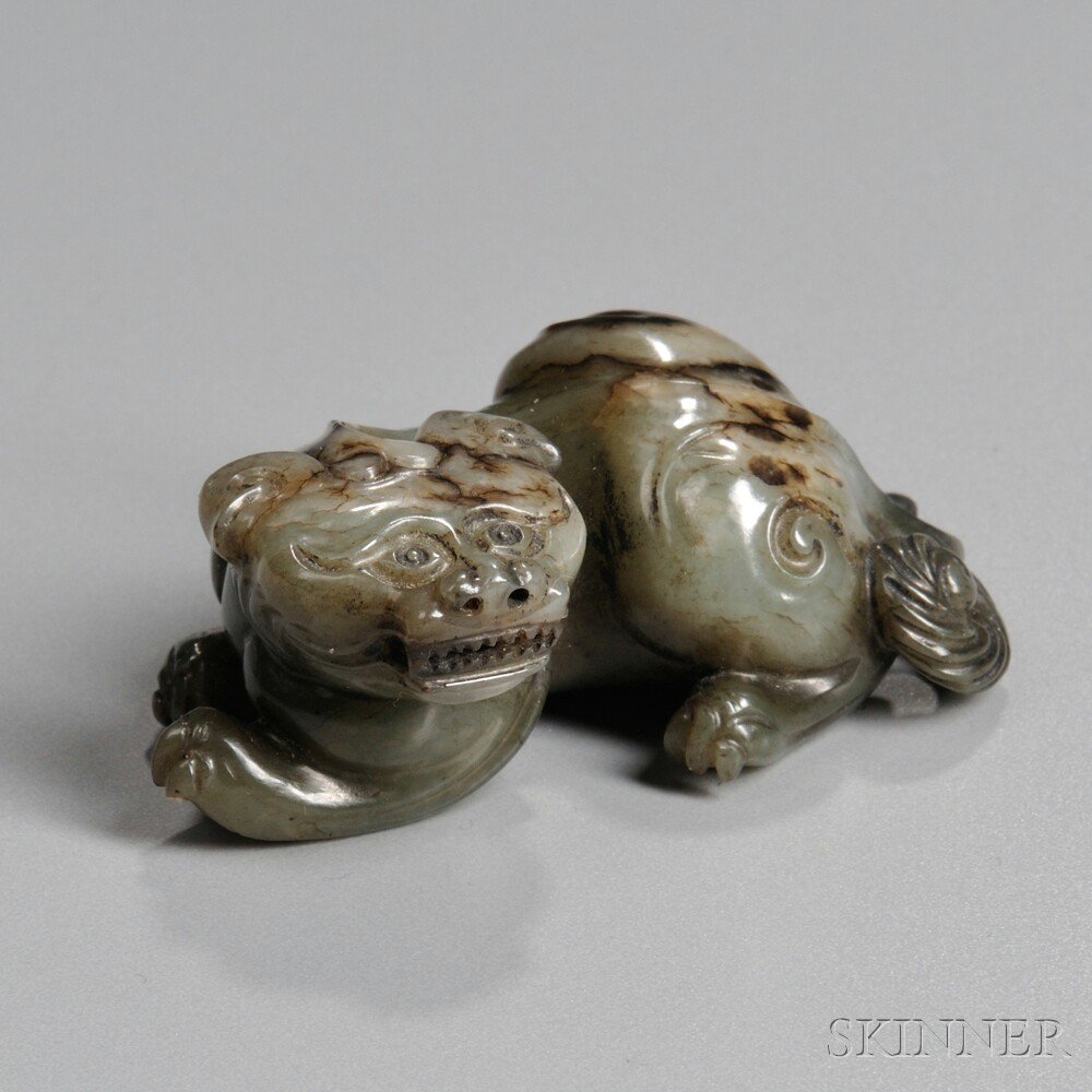 Appraisal: Jade Carving of a Mythical Animal China seated sideways with