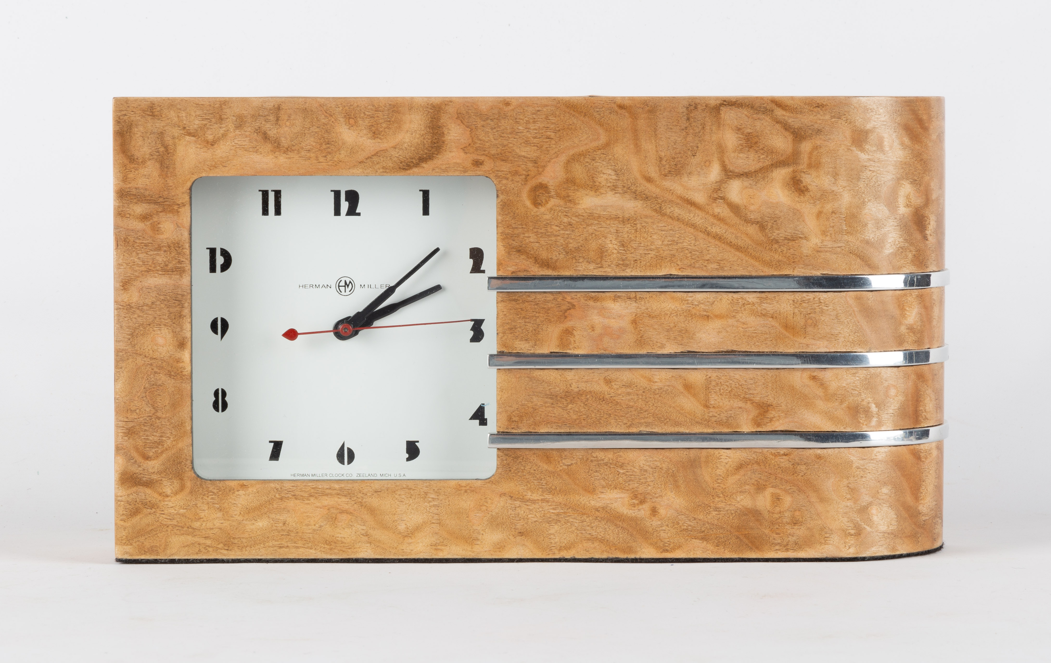 Appraisal: GILBERT ROHDE STYLE CLOCK Burl wood veneer and chrome plated-steel