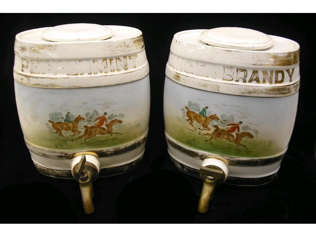 Appraisal: Pair of oval pottery spirit barrel dispensers each decorated with