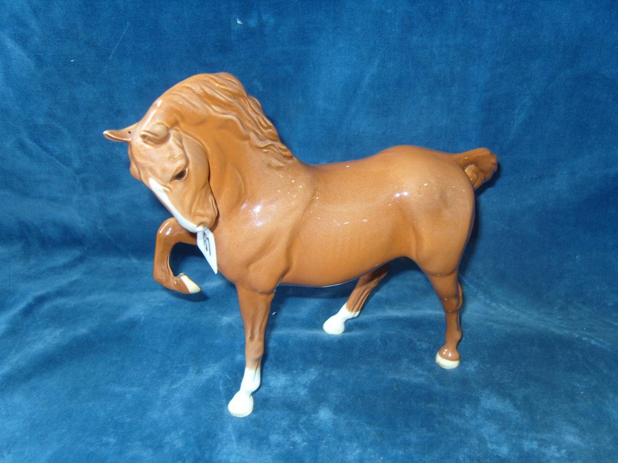 Appraisal: A Beswick model of a chestnut horse with foreleg raised