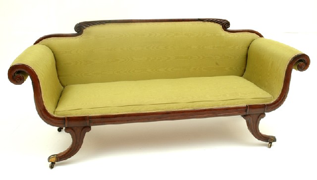 Appraisal: A REGENCY MAHOGANY SETTEE The shaped feather carved back flanked