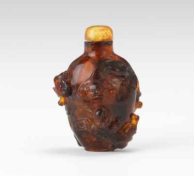 Appraisal: A Carved Amber Snuff Bottle With Three Kittens Natural amber