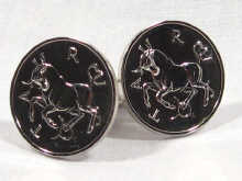 Appraisal: A pair of silver coin style cufflinks depicting Taurus the