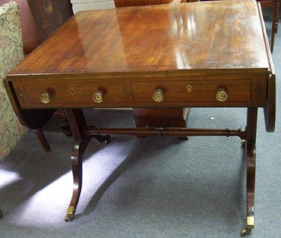 Appraisal: A th Century mahogany and inlaid sofa table fitted two