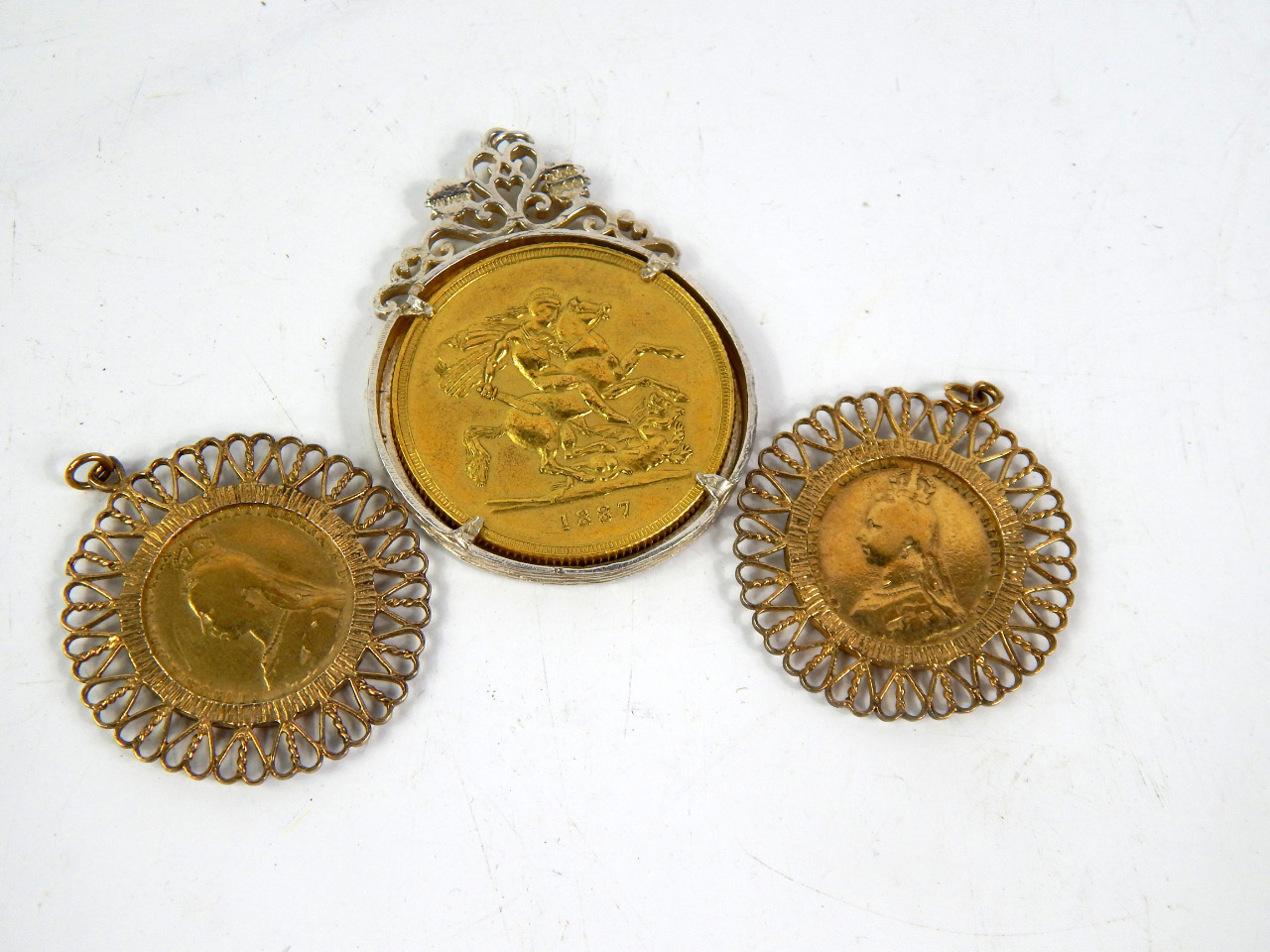 Appraisal: Two gilded Victorian sixpences and pendant mounted and a gilded