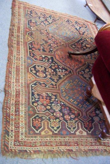 Appraisal: A bordered and figured Caucasian rug decorated a triple pole