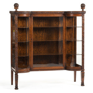 Appraisal: A Carved Oak Vitrine Cabinet and Open Bookshelf Late th