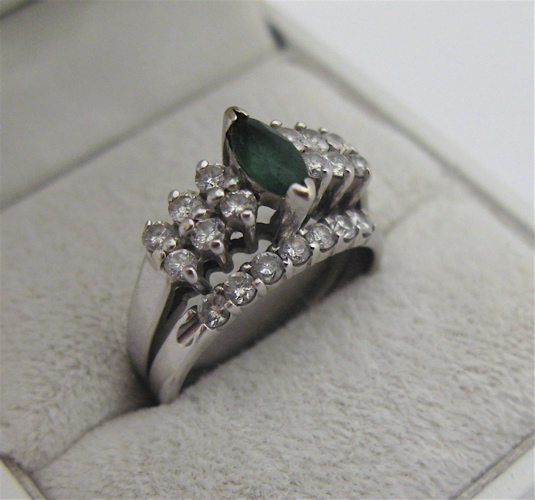 Appraisal: EMERALD DIAMOND AND KARAT WHITE GOLD WEDDING RING centering a