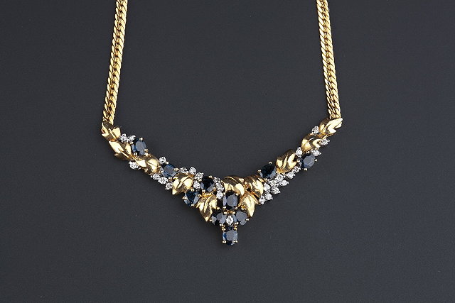 Appraisal: A sapphire and diamond set necklace the wishbone-shaped pendant set