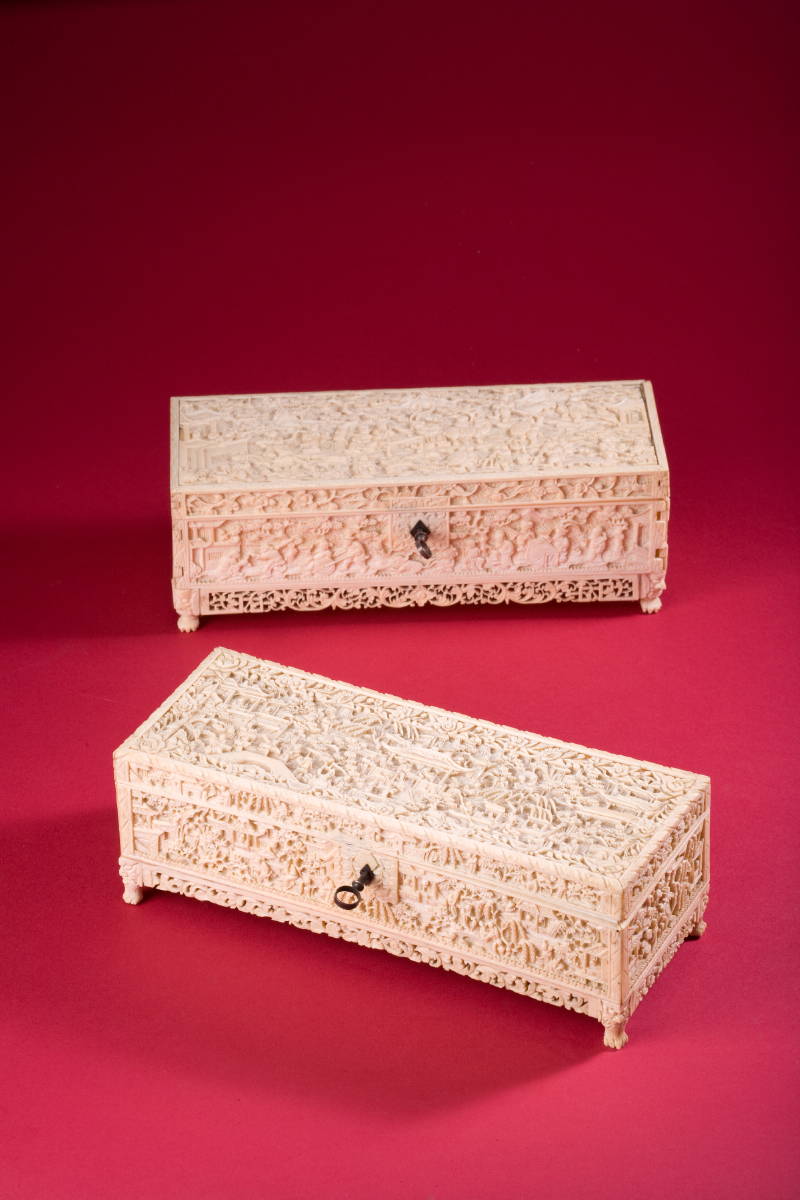 Appraisal: TWO RECTANGULAR CARVED IVORY LOCKING GLOVE BOXES DEPICTING CHINESE SCENES