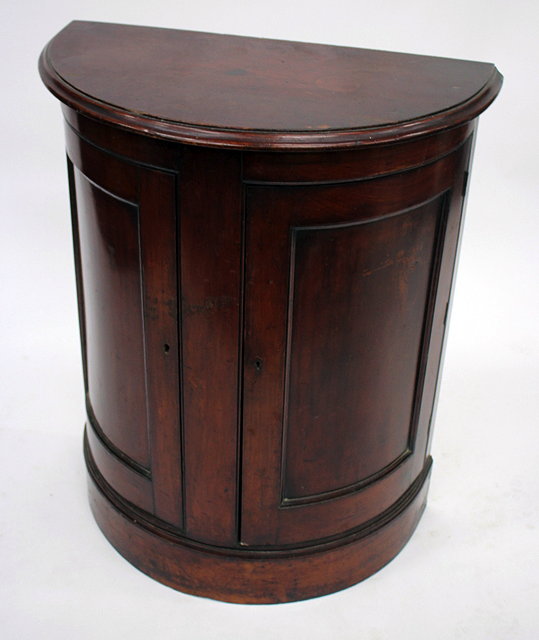 Appraisal: A TH CENTURY MAHOGANY BOW FRONTED CABINET with twin panelled