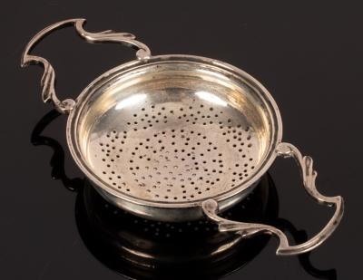 Appraisal: A two-handled silver tea strainer Sheffield cm wide approximately gm