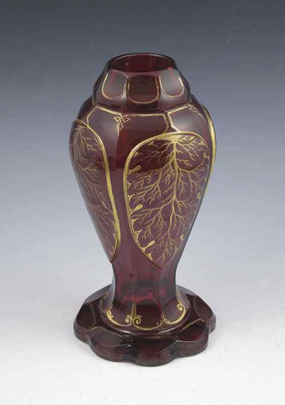 Appraisal: EARLY BOHEMIAN RUBY GLASS VASE Facet cut scalloped rim gilt