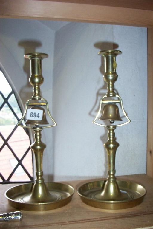 Appraisal: A pair of brass tavern candlesticks fitted with bells to