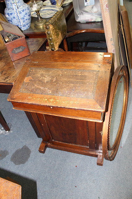 Appraisal: AN OLD WALNUT DAVENPORT with leather inset sloping front and