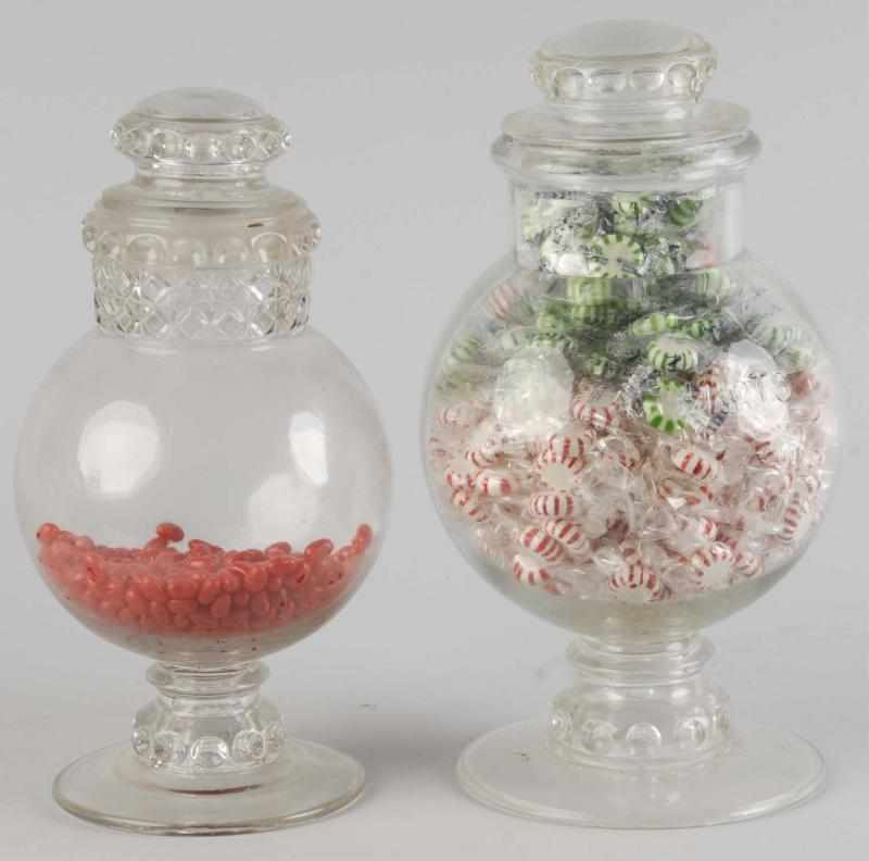 Appraisal: Lot of Early Glass Store Jars Description Larger jar has