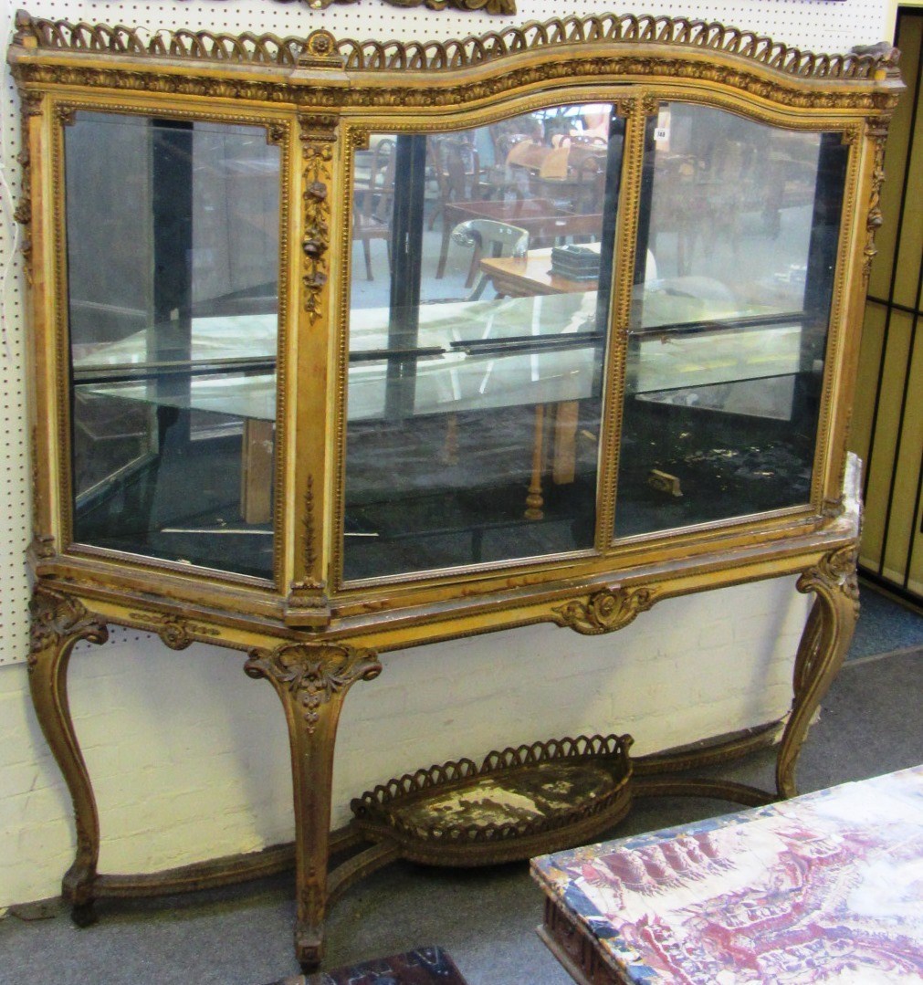 Appraisal: A large th century gilt framed display cabinet with pierced