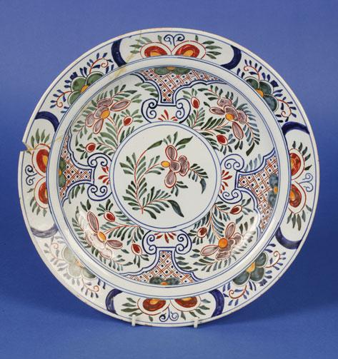 Appraisal: A DELFT POLYCHROME CHARGER th century painted with stylised and