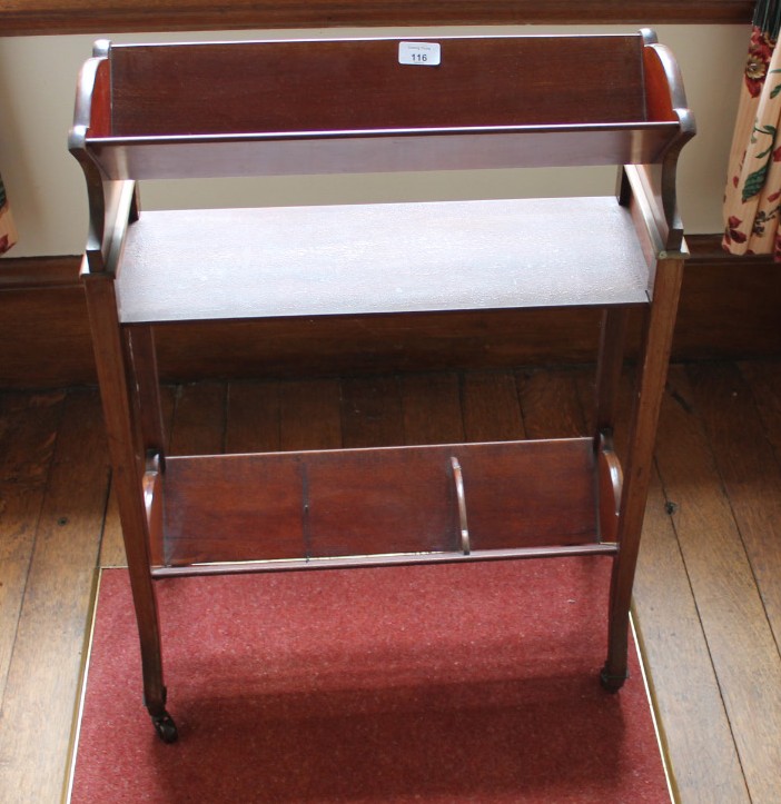 Appraisal: An Edwardian mahogany book trough with shell and stringing inlays