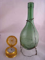 Appraisal: A moulded green glass bottle ht cm and a gilt