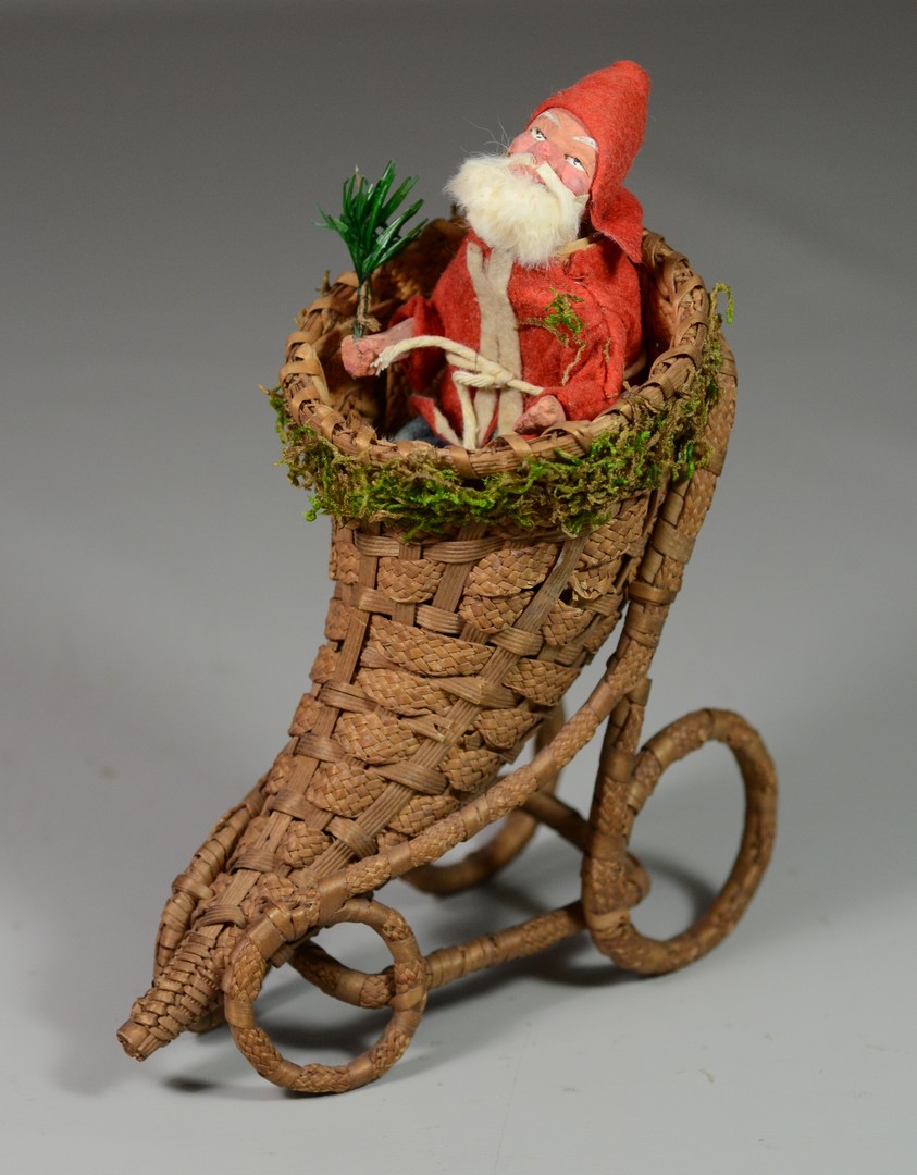 Appraisal: Felt paper mache Santa candy container on wicker cornucopia removable