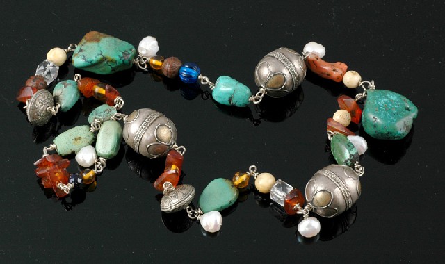 Appraisal: A TRIBAL STYLE NECKLACE Hand crafted comprising tumbled turquoise amber