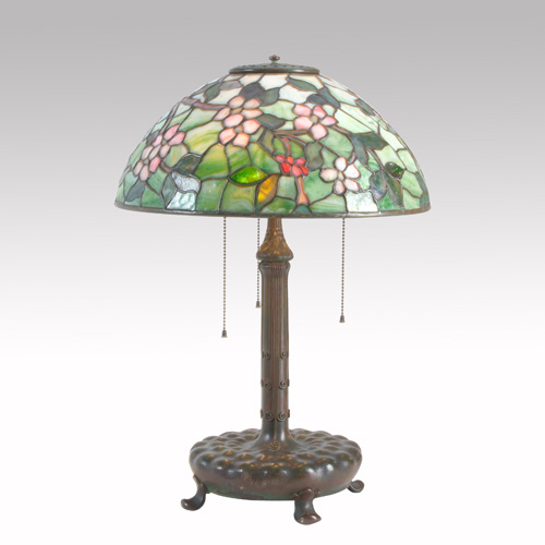 Appraisal: TIFFANY STUDIOS Table lamp its hemispherical shade in the Apple