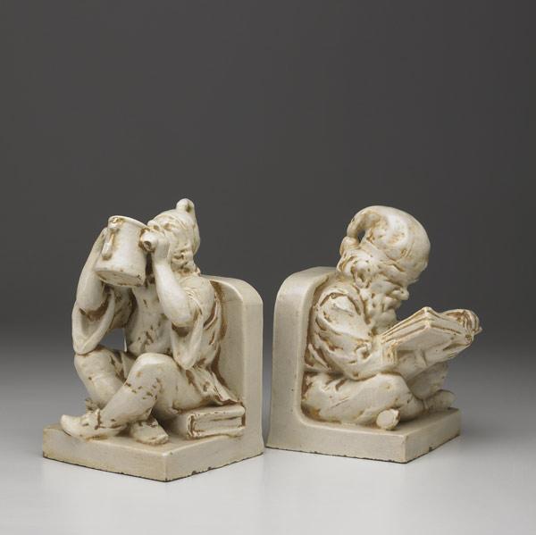 Appraisal: NORTHWESTERN TERRACOTTA CO Figural bookends with monks reading and drinking