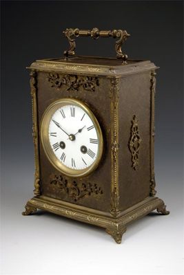 Appraisal: A French floral engraved brass mantle clock with an day