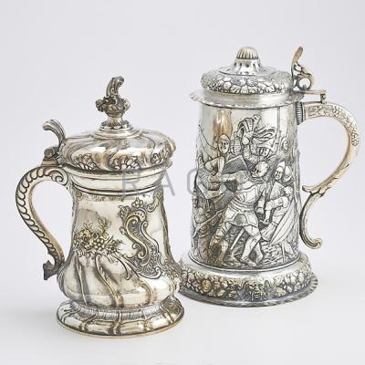 Appraisal: TWO MASSIVE DECORATIVE SILVER PLATED TANKARDS Electroplated copper embossed with