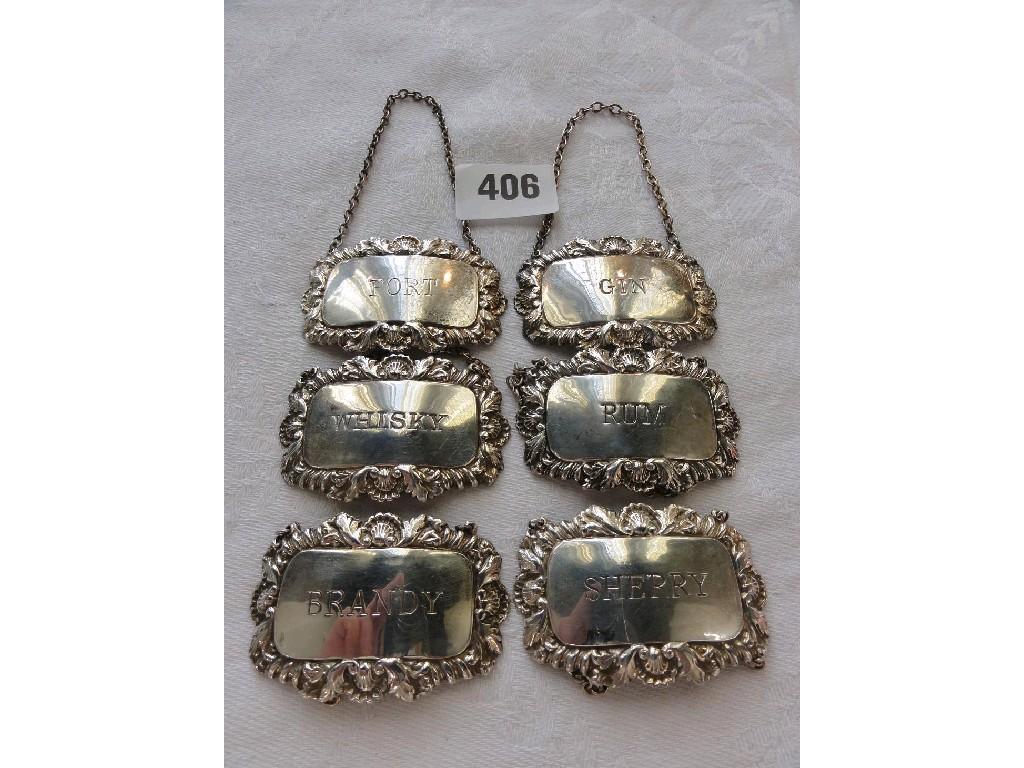 Appraisal: A set of six silver decanter labels with relief and