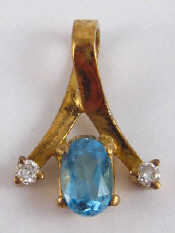 Appraisal: An carat gold blue topaz and diamond pendant approx cm