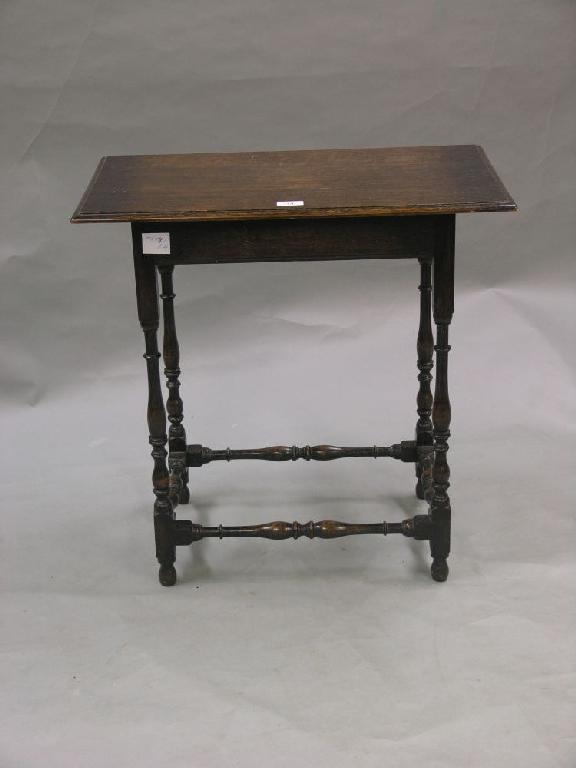 Appraisal: A solid dark oak occasional table on baluster turned legs