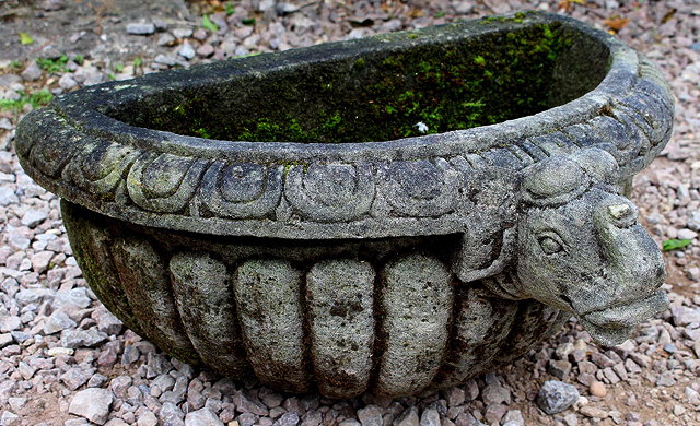 Appraisal: A 'D' SHAPED CARVED STONE TROUGH with a fluted bowl