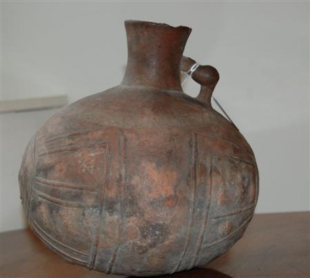 Appraisal: TERRACOTTA SINGLE HANDLED VESSEL with ribbed decoration cm high