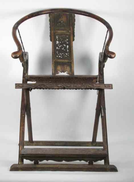 Appraisal: A Chinese folding armchair with carved splat back and hooped