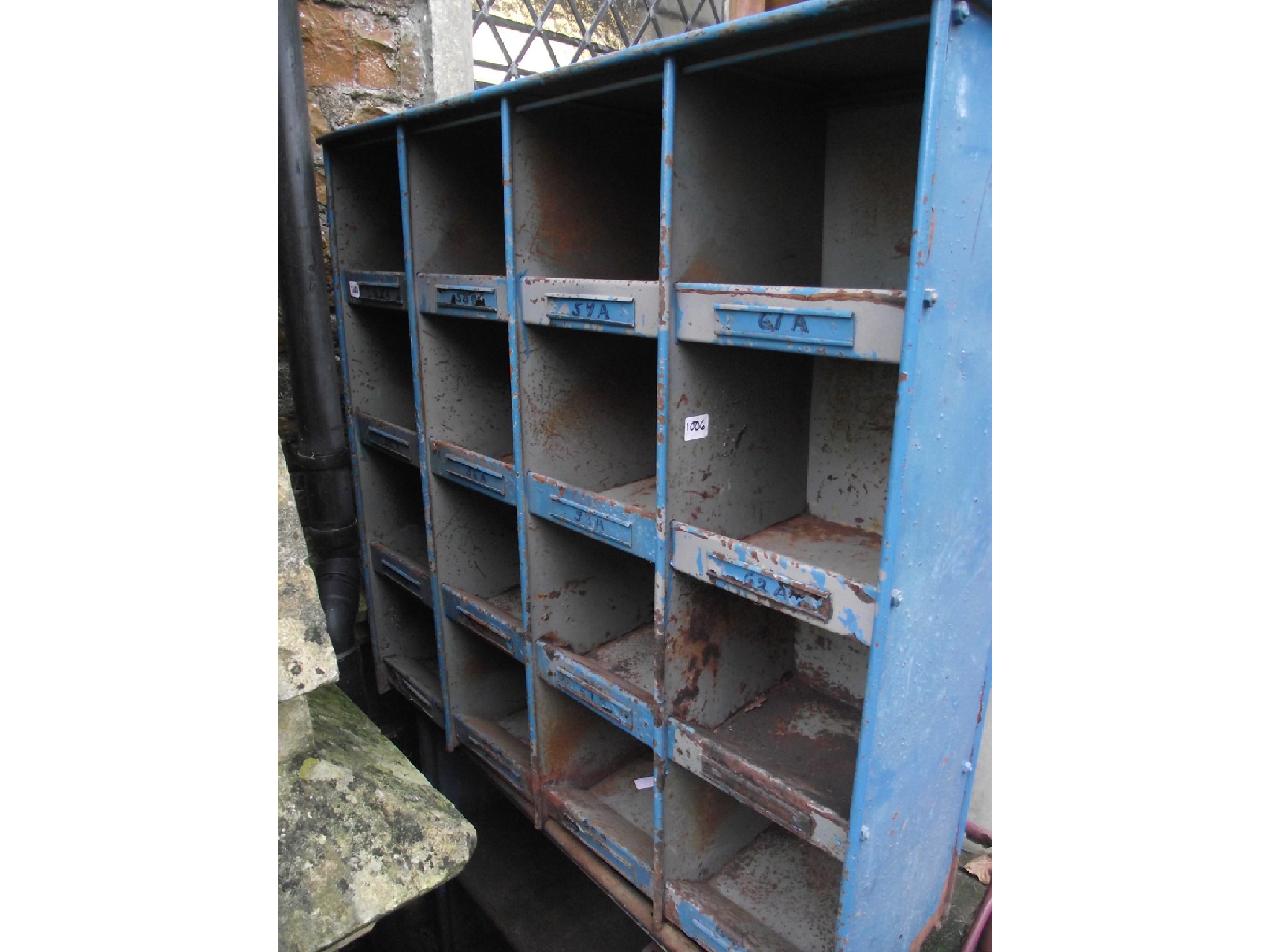 Appraisal: A vintage flight of steel framed industrial pigeon holes with