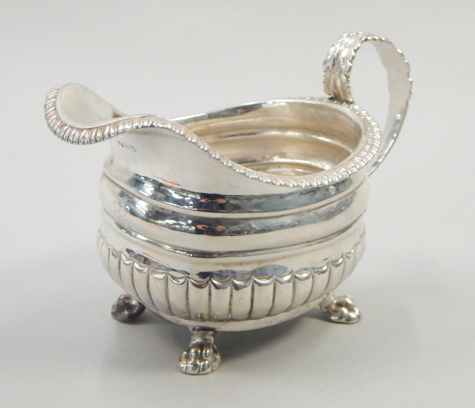 Appraisal: A George IV silver milk jug with a gadrooned edge