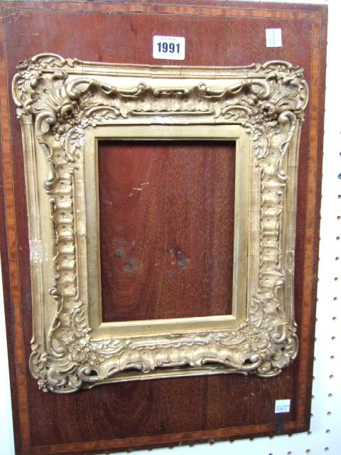 Appraisal: A th century gilt gesso swept picture frame aperture cm