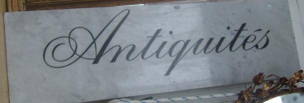 Appraisal: A marble plaque painted with the word Antiques probably a