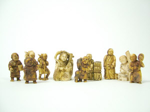 Appraisal: A Japanese ivory netsuke carved as a female musician signed