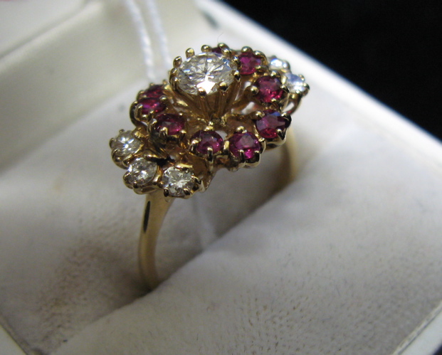 Appraisal: DIAMOND RUBY AND FOURTEEN KARAT GOLD RING centering a round-cut