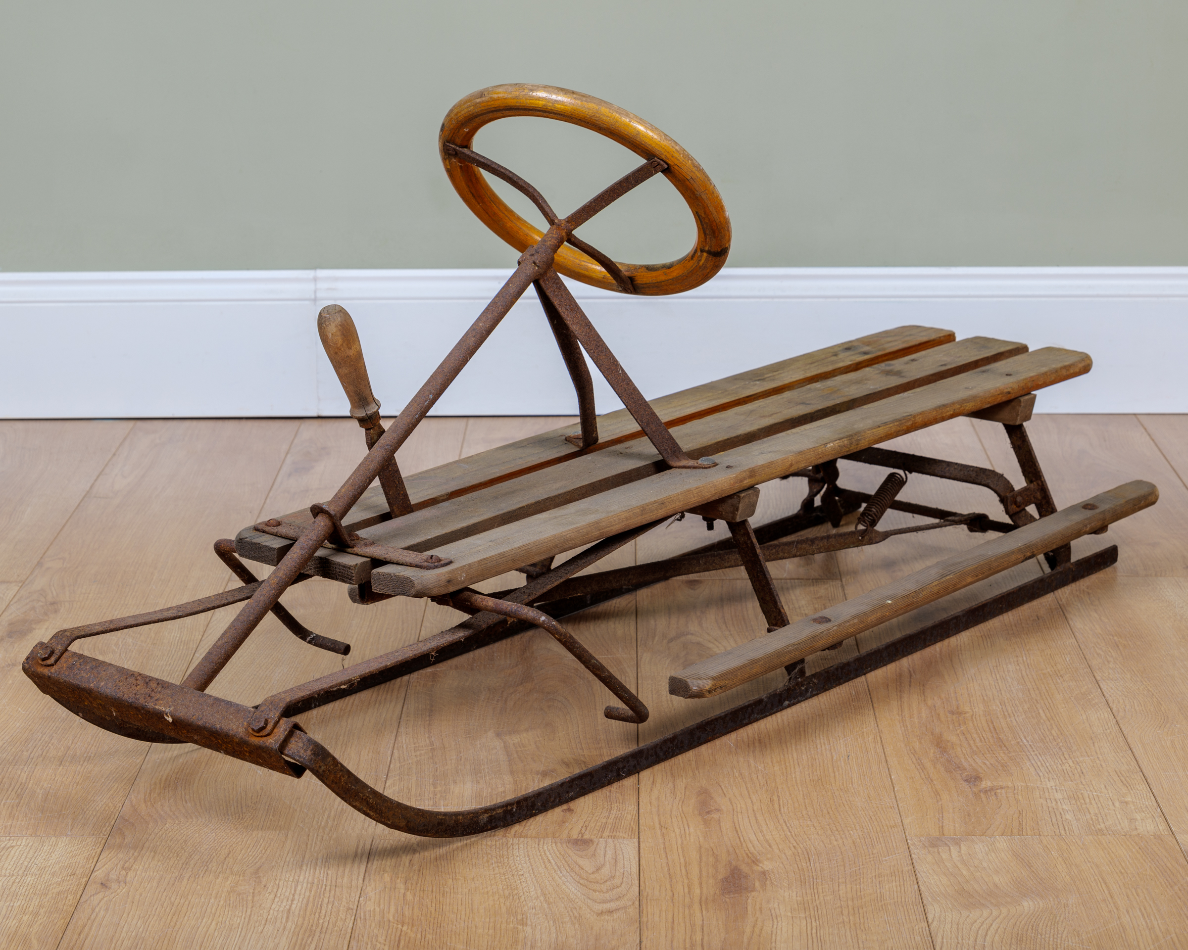 Appraisal: A pine and iron toboggan with bentwood steering wheel and