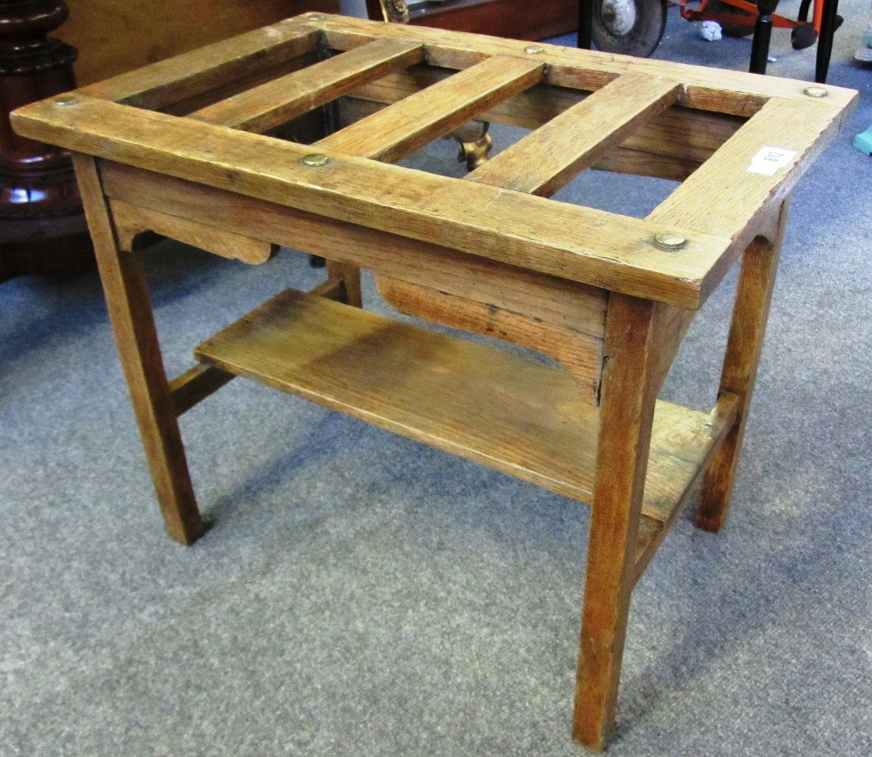 Appraisal: A slatted oak luggage stand with brass studded decoration cm